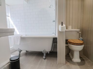 A bathroom featuring a bathtub, toilet, and sink at The Little Rose in Lyme Regis