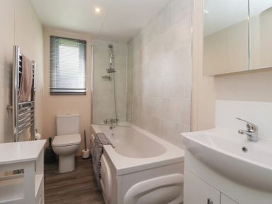 A bathroom with a bath tub and a toilet at Away Daze in Carnaby near Bridlington