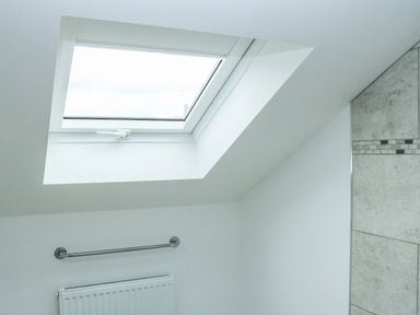 A bathroom skylight window above a towel rail and radiator at Sawtons Cottage 2 in Dawlish