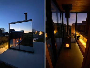 A glass structure with a stove and bench at Low Longlands in Cartmel