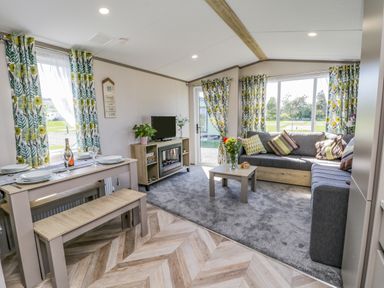 A living room with a corner sofa table and TV unit at Jean's Place in East Heslerton near West Heslerton