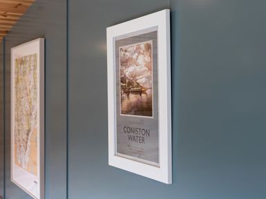 A close-up of two framed pictures on a blue wall at High Longlands in Cartmel