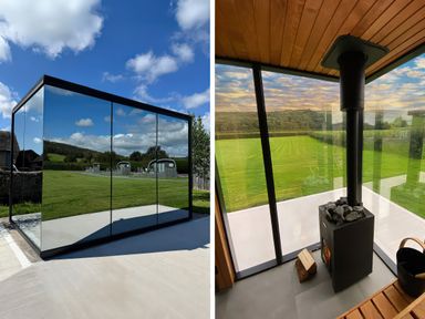 A glass structure with wood stove and seating at Little Heaning in Cartmel
