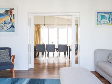 A living room with a sofa and an armchair at Beach Haven in Perranporth