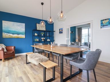 A dining room with a table and chairs at Beach Haven in Perranporth