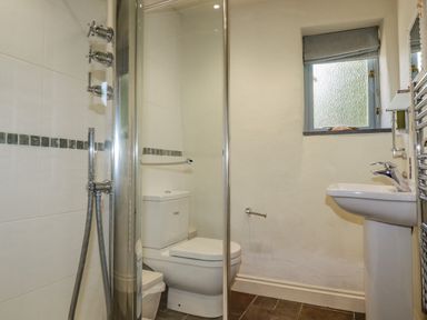 A bathroom with a toilet a sink a shower and a window at Cameo Atlantic Highway near Bude
