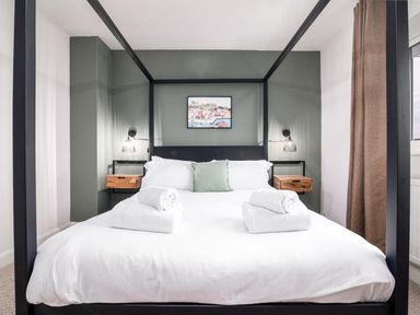 A bedroom with a four poster bed and bedside shelves at The View in Whitby