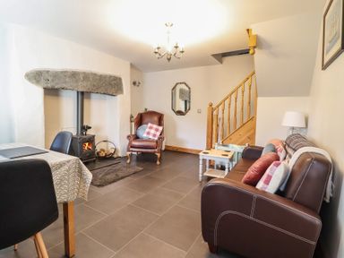 A living room with a fireplace and seating area at Bridgeway House in Blaenau Ffestiniog