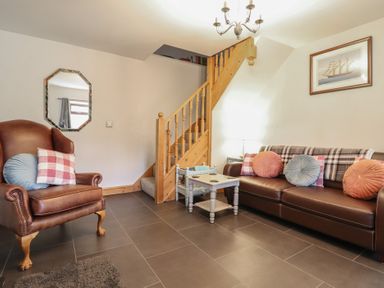 A living room with a sofa and armchair at Bridgeway House in Blaenau Ffestiniog