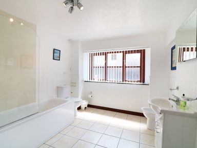A bathroom with a bathtub toilet sink and window blinds at The Corn Tallet in Westleigh near Bideford