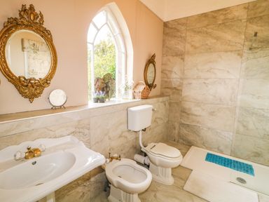 A bathroom with a sink bidet toilet shower and two round mirrors at Scarvagh House Scarva near Loughbrickland