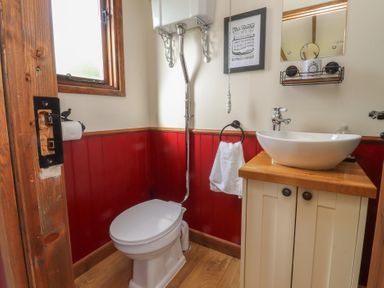 A bathroom with toilet and sink at The Journeyman Luxury Shepherds Hut in Barnoldswick
