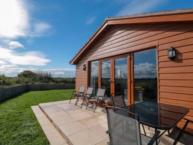 An outdoor area with a table and chairs at Delphine Lodge, Meadow View Lodges, Brean
