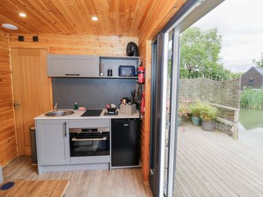 A kitchen with appliances and sink at Maple Lodge at Bridge Lake Farm & Fishery in Chacombe