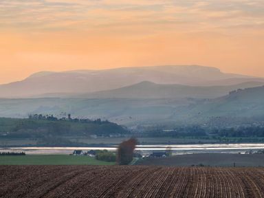 A rural landscape with plowed field houses water and hills at Skylarks in Ferintosh near to Dingwall