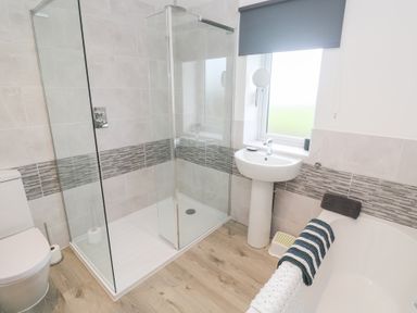A bathroom with a walk-in shower a toilet a pedestal sink and a bathtub at Atlantic Reach in Marazion