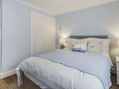 A bedroom with a double bed pillows bedside tables and lamps at Apartment 18 Burgh Island Causeway in Bigbury-On-Sea