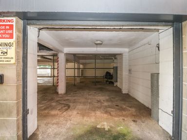 An empty underground parking space marked with number 4 at Townbridge Apartment in Weymouth