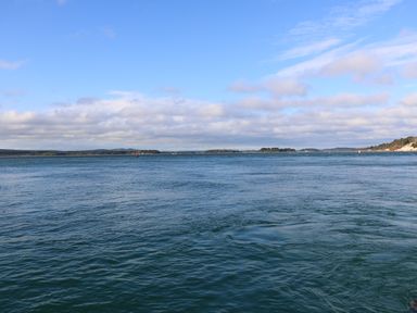 A large body of water with small islands and a partly cloudy sky at The Cottage in Wimborne Minster