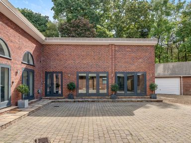 An outdoor area with brick walls and planters at The Cottage in Wimborne Minster