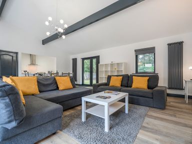 A living room with sofas and a coffee table at The Cottage in Wimborne Minster