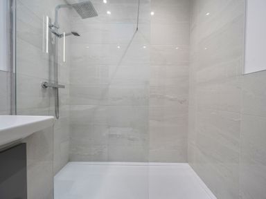 A shower area with a sink at The Cottage in Wimborne Minster