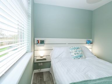 A bedroom with a double bed and a pillow with boats near a window with blinds at 12 Siesta Mar in Mundesley