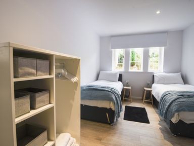 A bedroom with two single beds side by side each with white bedding and blue blankets at 1 Buckfields Lyme Regis