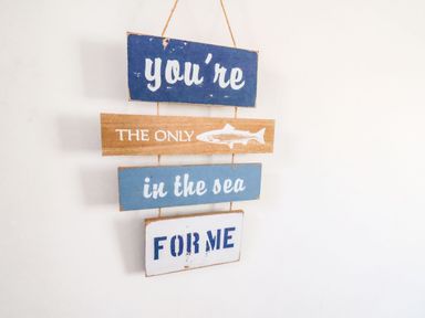 A wall hanging with wooden planks and text you're the only fish in the sea for me