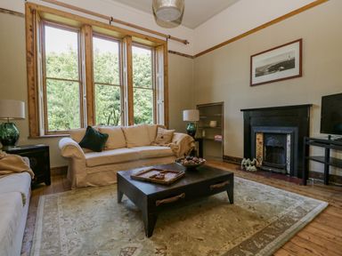 A living room with two sofas coffee table and a fireplace at The Residence in Cleator