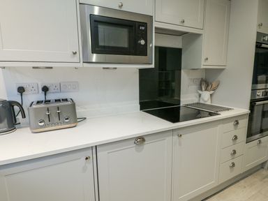 A kitchen with a toaster and kettle at White Sails in Y Felinheli