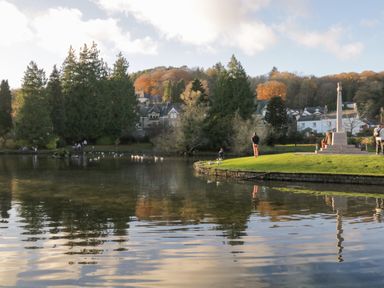 A park with a pond trees people walking and houses in the background at Little Barn in Grange-Over-Sands near Cartmel