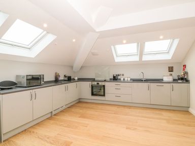 A kitchen with cabinets countertops oven microwave and skylights at Sardis Chapel 1 in Malltraeth