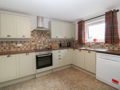 A kitchen with cabinets and appliances at Top Lodge in Llanvair-Discoed near Penhow