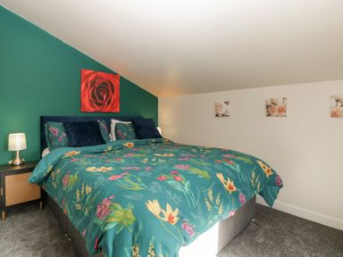 A bedroom with a bed and bedside table at Top Lodge in Llanvair-Discoed near Penhow