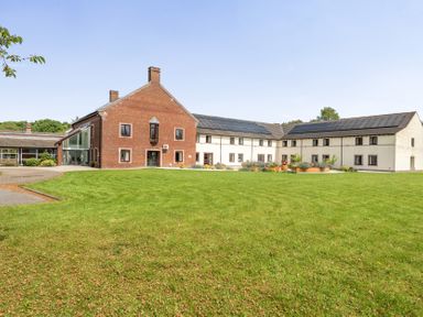 An outdoor view of a building with solar panels at Jubilee Two Bedroom House Pet Friendly in Penrith