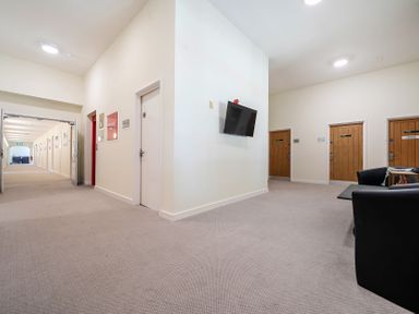 A hallway with doors and a television at Jubilee Two Bedroom House Pet Friendly Penrith