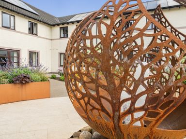 An outdoor area featuring a rust-colored sculpture and planter at Jubilee Two Bedroom House Pet Free Baby Friendly in Penrith