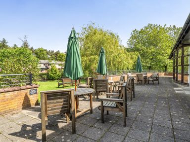 An outdoor seating area with tables and chairs at Jubilee Two Bedroom House Pet Free Baby Friendly in Penrith