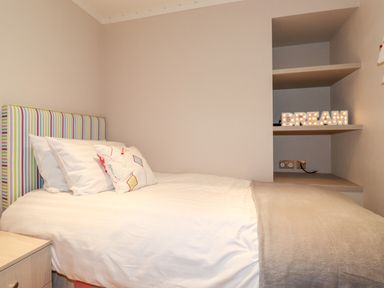 A bedroom with a bed a bedside table and shelves with a lighted dream sign at Loubi's Lakeside Lodge M1 Fallbarrow Park near Bowness-On-Windermere