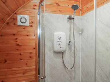 A shower with a showerhead and wall heater in Beech Ulverston