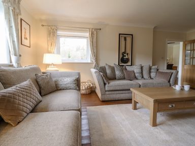 A living room with two sofas and a wooden coffee table at Tan Yr Allt in Dolanog near Meifod Powys