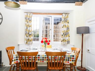 A dining room with a table set for dinner at The Abbey Grange near Charmouth