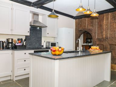 A kitchen with an island and appliances at The Abbey Grange near Charmouth