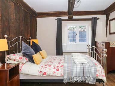 A bedroom with a bed and window at The Abbey Grange near Charmouth
