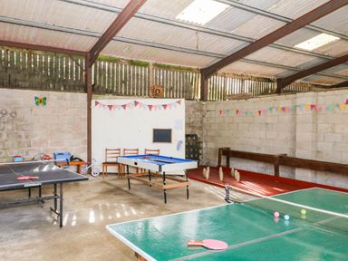 A recreation room with ping pong tables and table football at The Abbey Grange near Charmouth