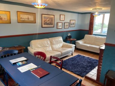 A living room with sofas and a table at 11 Penygroes in Llanddeusant