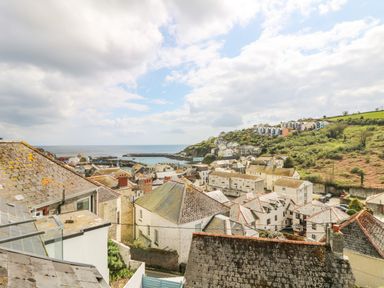 A coastal village with houses on a hillside near the ocean at Chy An Mor in Mevagissey