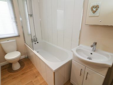 A bathroom with a toilet bathtub and sink at Waterside Lodge South Lakeland Leisure Village near Carnforth