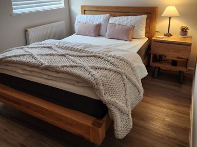 A bedroom with a bed and bedside table at 8 Arvonia Terrace in Cricieth
